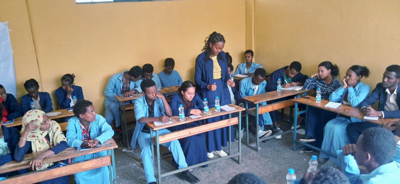 Youth capturing memories during a program